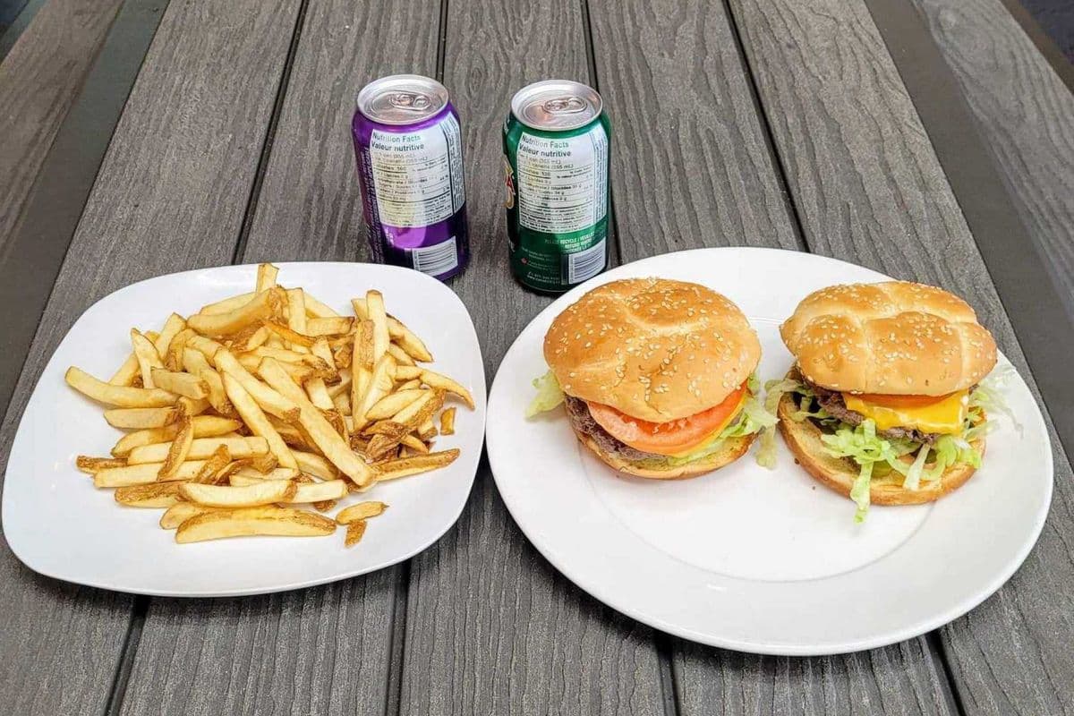 Two Cheese Burgers w/ Fries & Two Cans of Pops