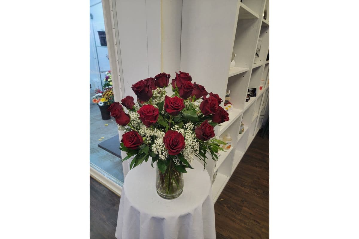 Dozen Long Stems Roses Arranged in a Vase with Filler