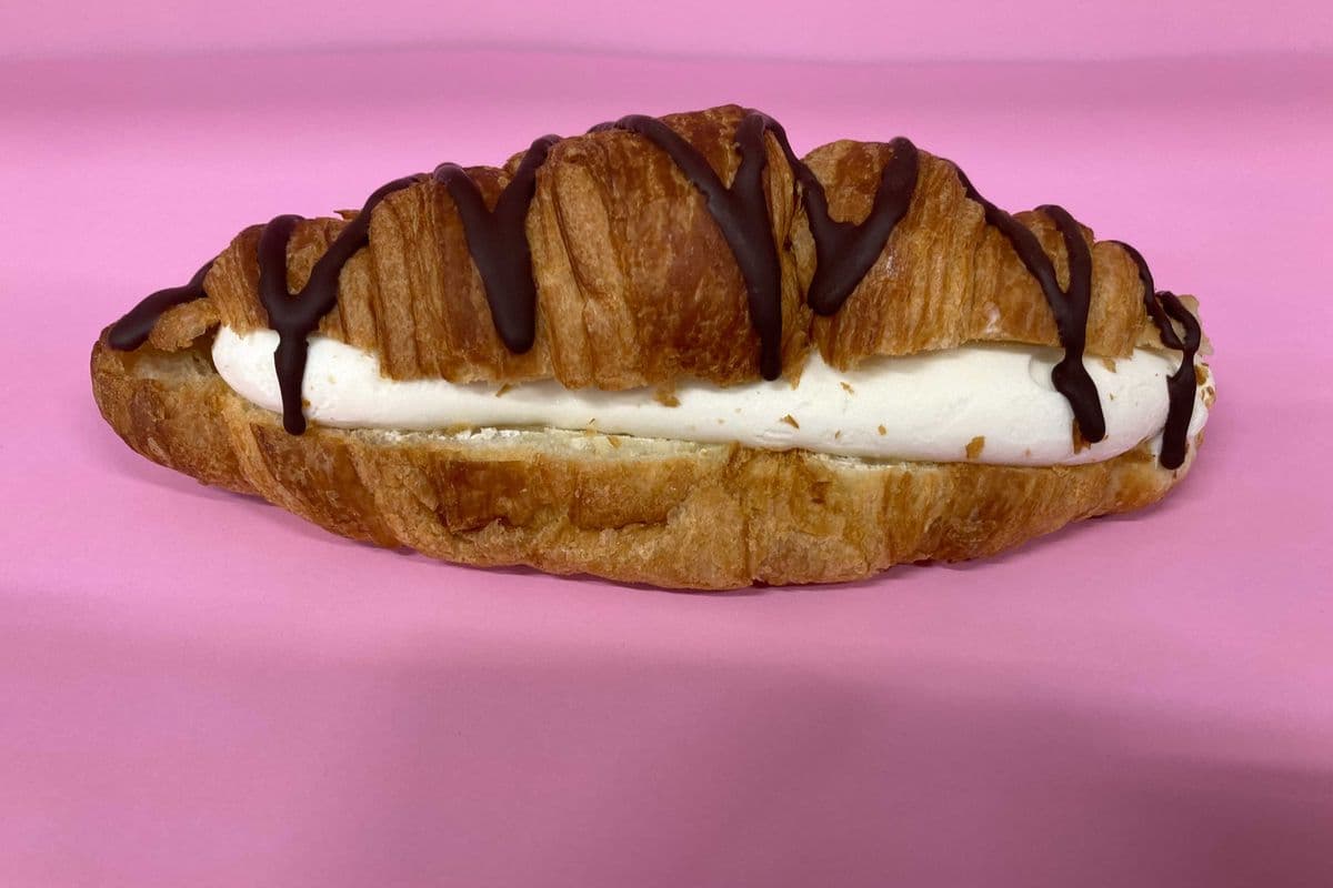 Croissant stuffed with vanilla ice cream, caramel syrup & chocolate drizzle
