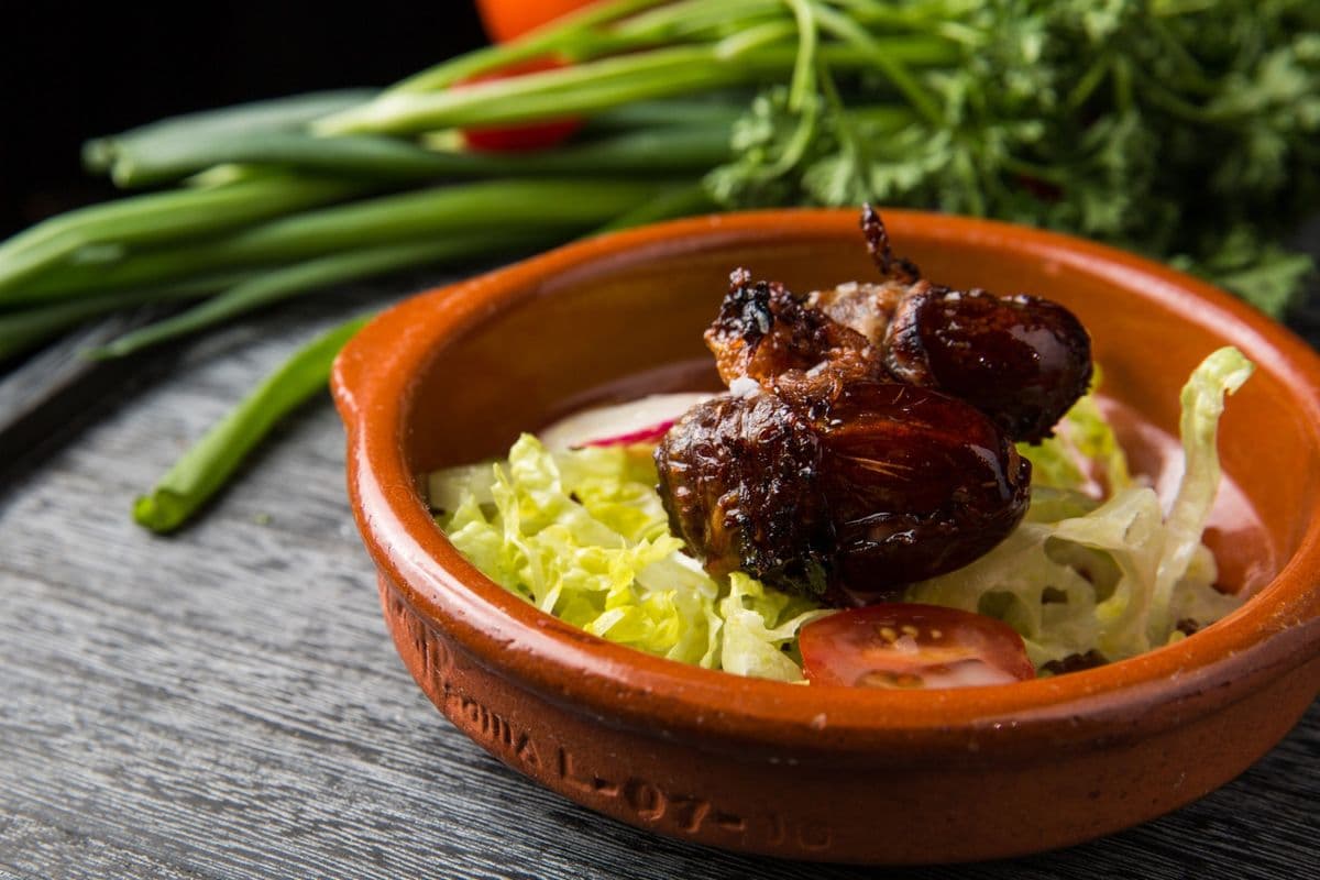 Three dates, Stuffed with Goats Cheese, and Wrapped in Bacon