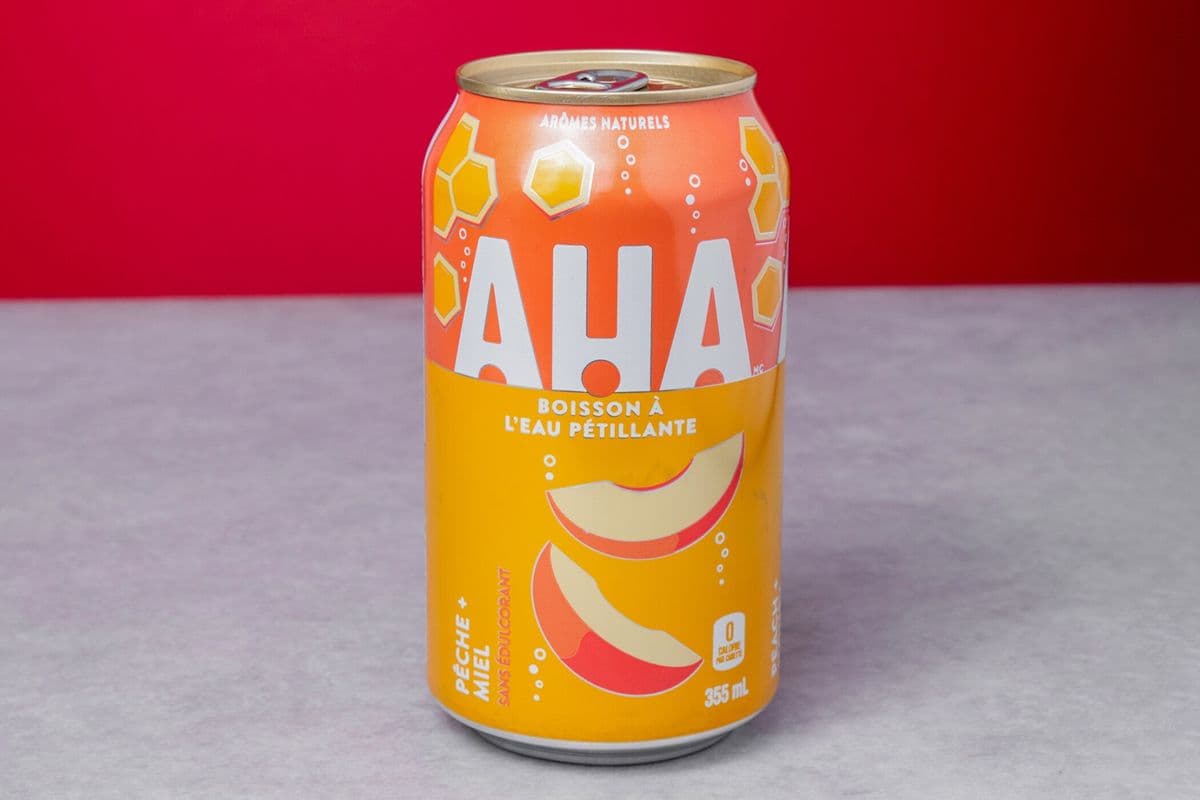 Eau petillante AHA (saveur pêche + miel)