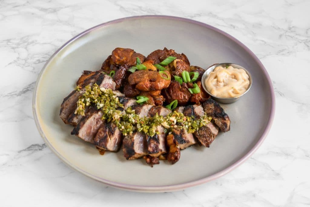 Sliced Steak and Rustic Smashed Patatas Bravas