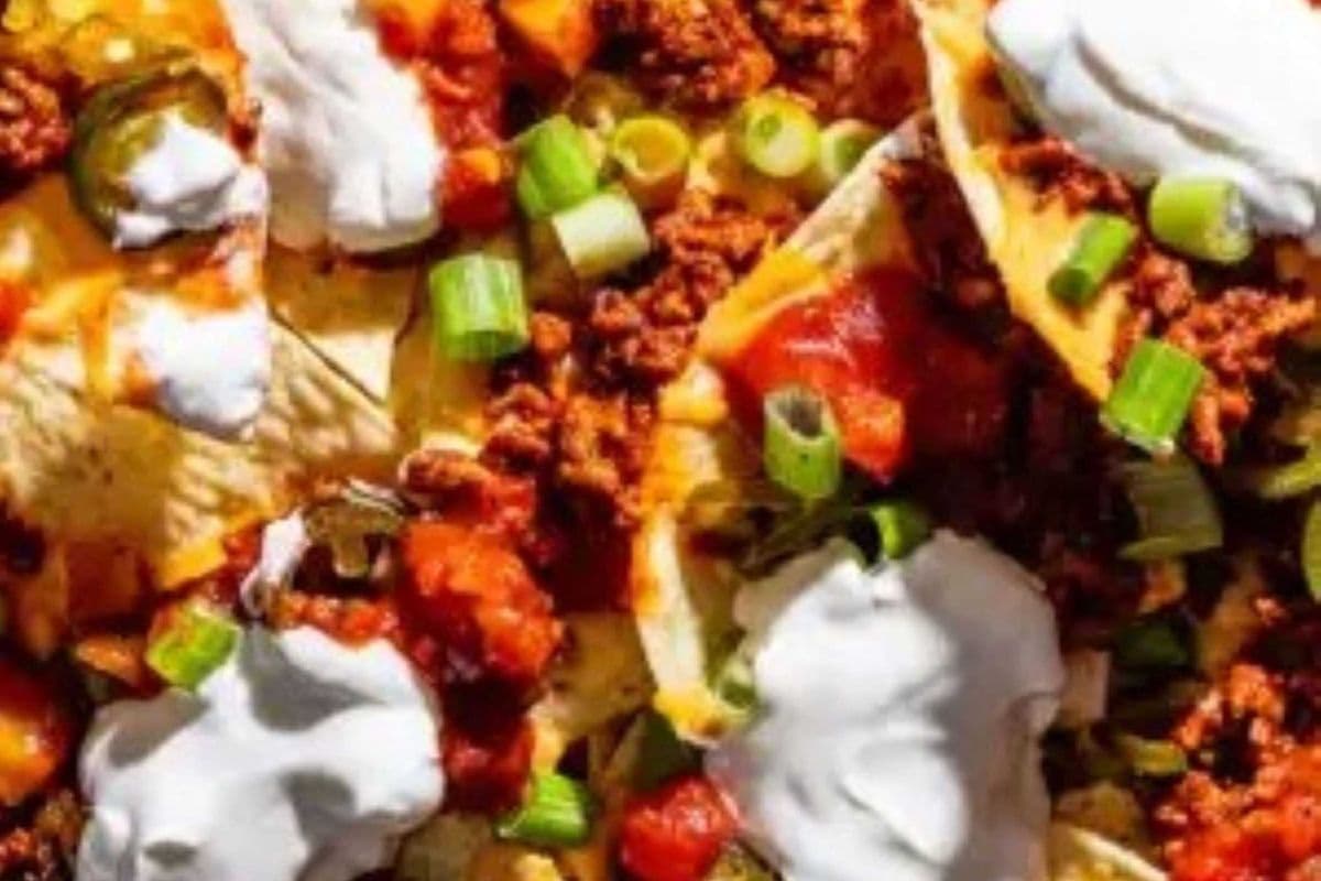 Nachos; Lettuce, Tomato, Green Onion and Jalapenos, served with Salsa and Sour Cream...