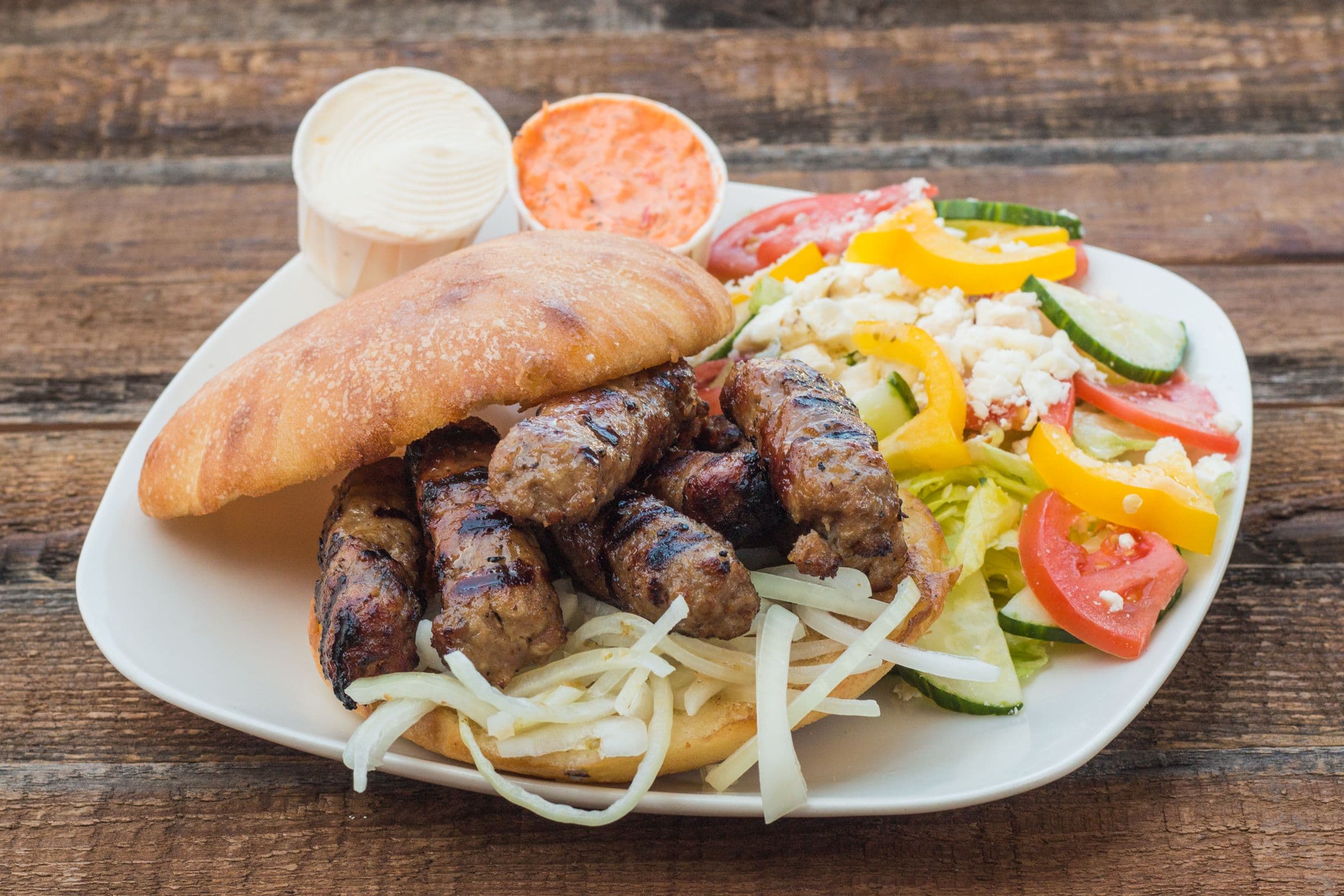 Chevaps (AllBeef) Sandwich 8-Pics Ground beef meat rolls served on a bun with your choice of side.