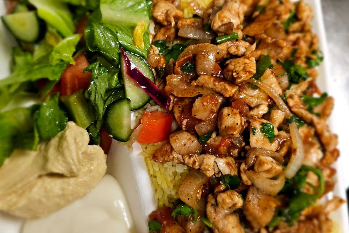Chicken shawarma, rice, potatoes, salad, and garlic sauce