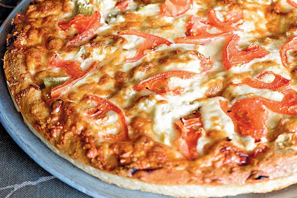 #31 Artichokes, Feta Cheese, Tomatoes, and Fresh Garlic Pizza
