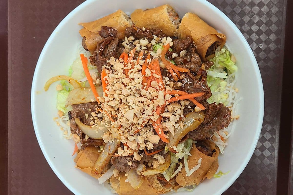 31f. Stir Fried Beef, Onion, and Curry or Satay Fresh Lemon Grass and Spring Rolls on Rice Vermicelli