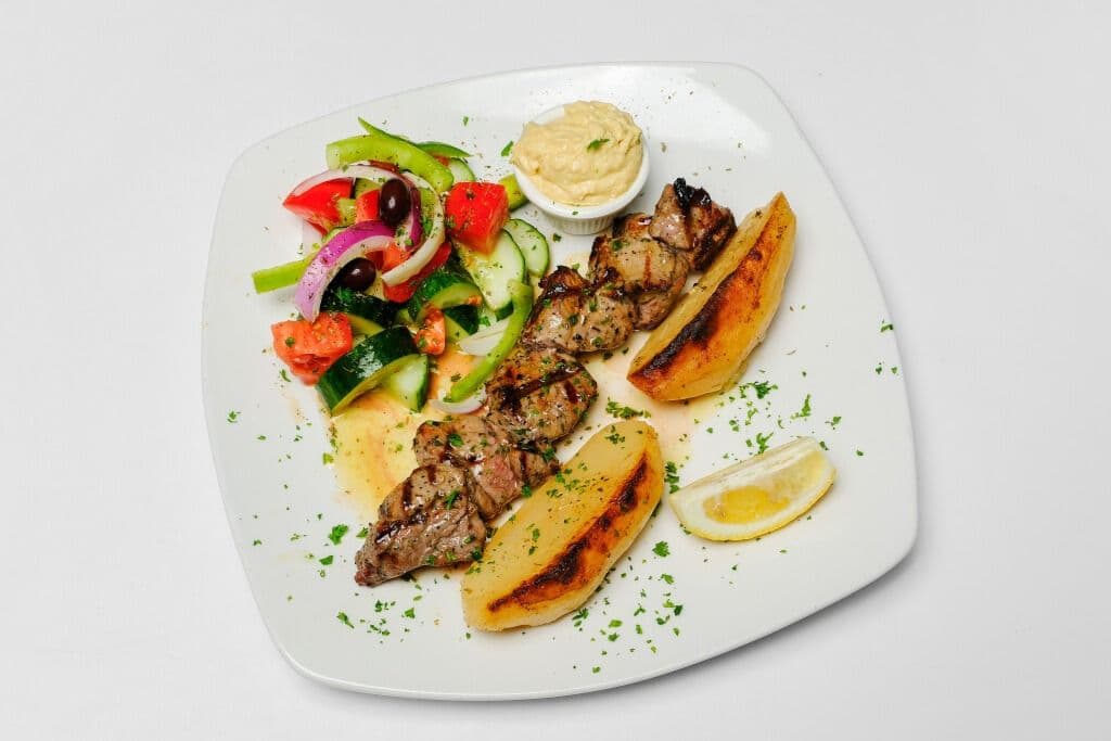 LAMB SOUVLAKI - 8-9 oz New Zealand spring lamb tenderloin. Comes with-roast potatoes Greek salad - OR- rice, mixed roast vegetables, potato