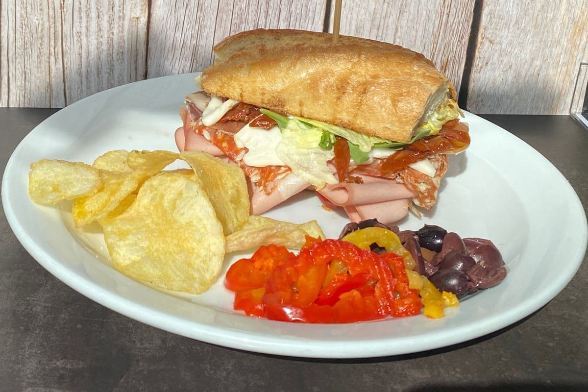 Cornerstone Cafe and Deli - Imported Italian deli muffuletta on Demi baguette