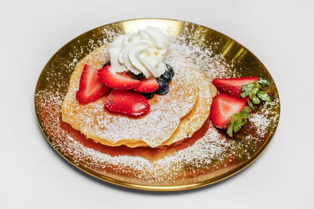 Three Pancakes, Maple Syrup, and Whipped Cream