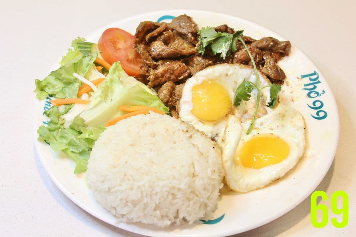 69. Two Sunny-Side Up Eggs with grilled Lemongrass Pork Slices on Rice