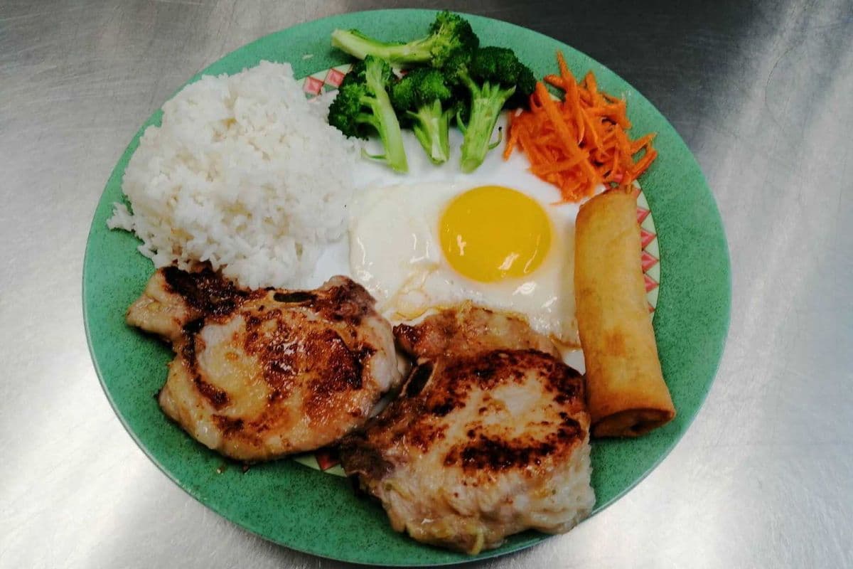 Lemon Grass Pork Chop, Fried Egg, Veggies and Spring Roll On Steamed Rice