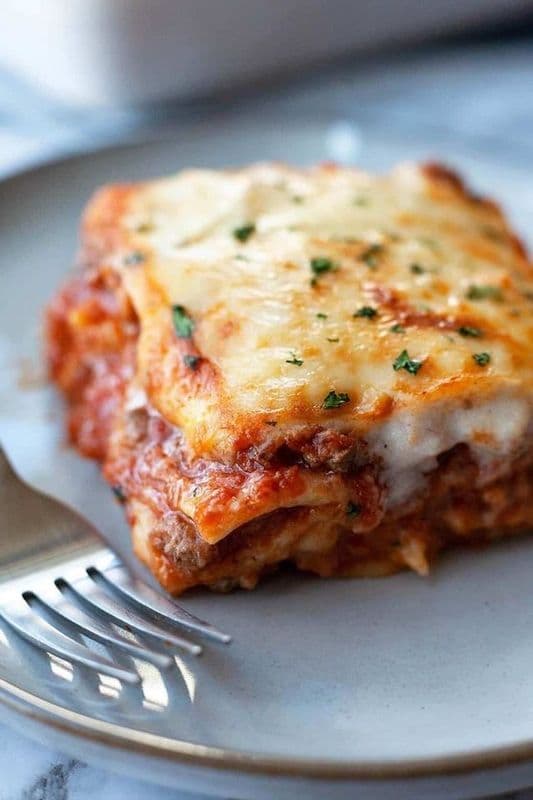Sam’s Homemade Lasagna with Caesar Salad and Garlic Bread