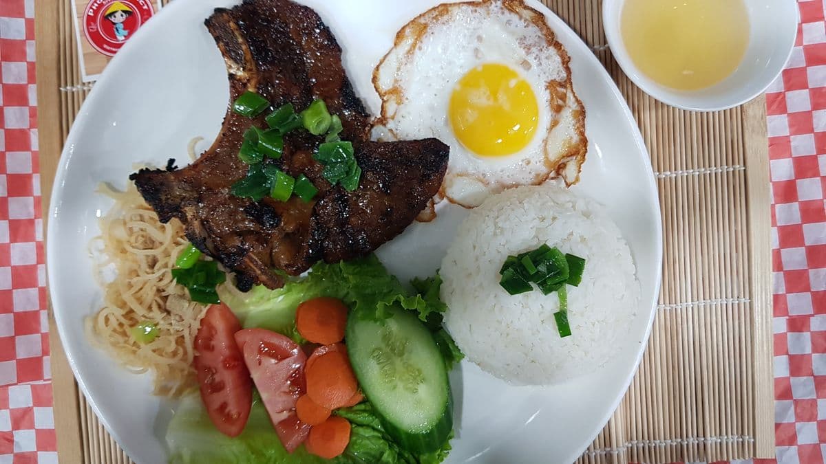 #402. Grilled Pork Chop, Fried Egg, and Spring Roll on Rice (Com suon nuong, trung opla, cha gio)