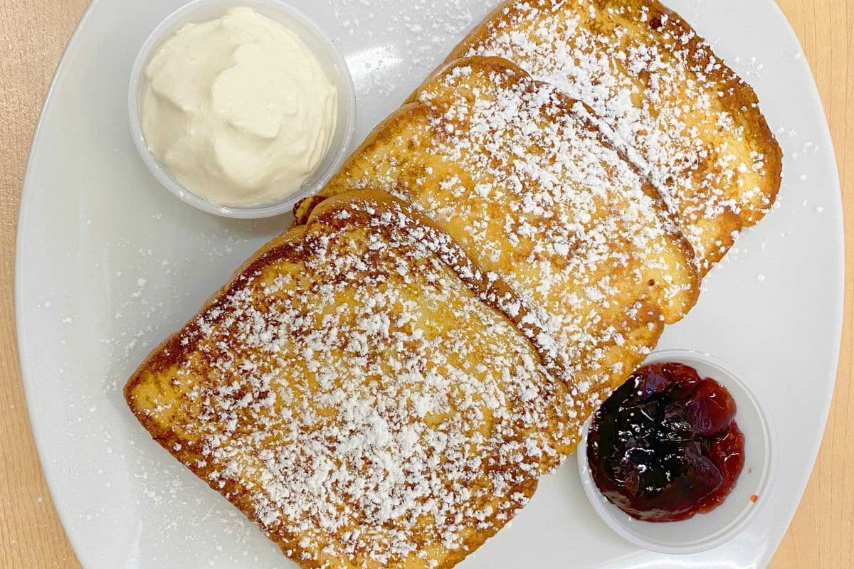 French Toast with Whipped Cream, Strawberry Jam and Icing Sugar