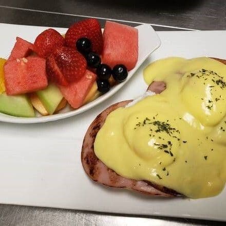 Eggs Benedict with Ham and Fruits