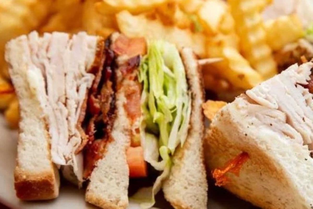 CLUB Sandwich; Chicken, lettuce ,tomato, bacon, cheese and mayo (have it in wrap) with fries