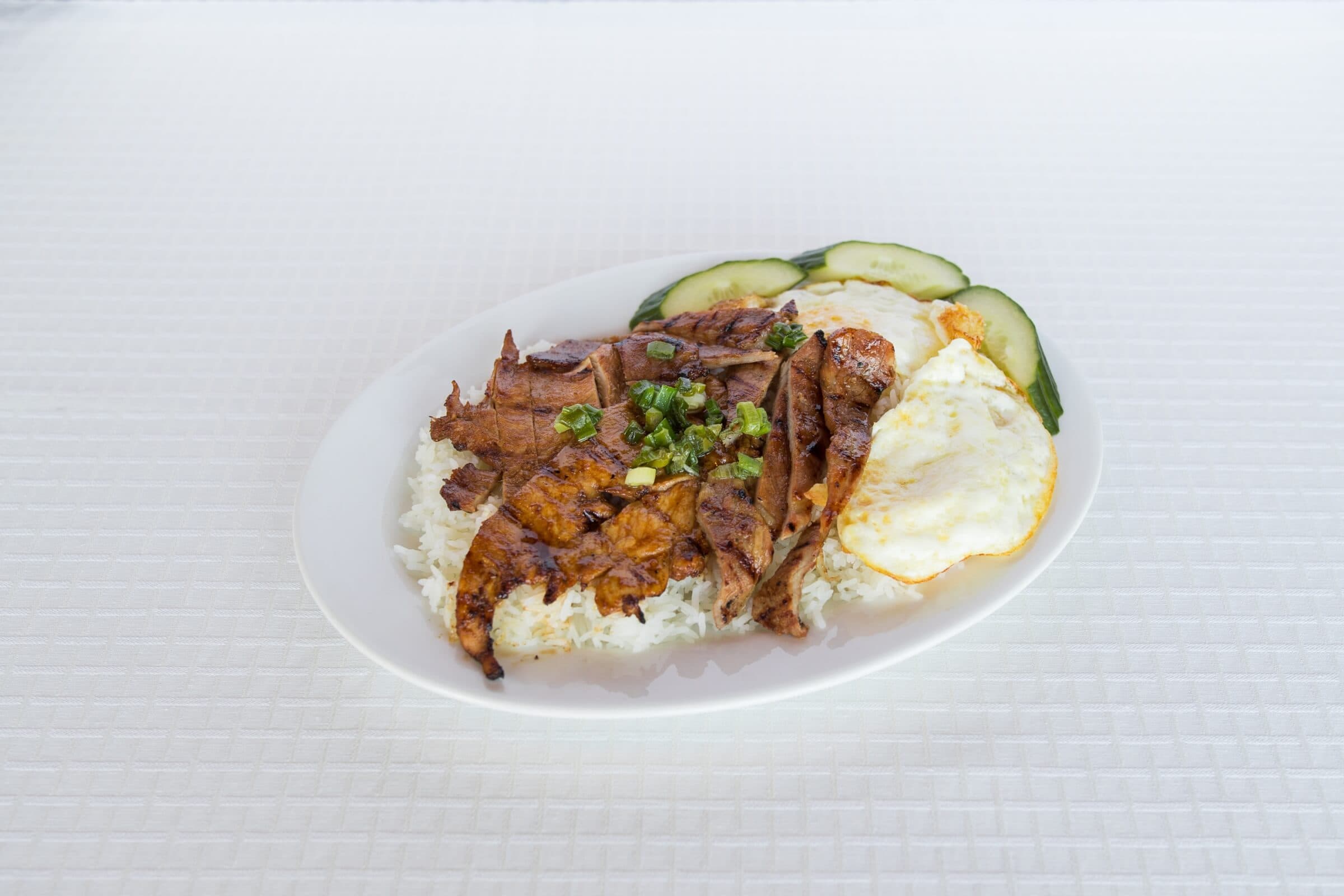 36B. Charbroiled Pork, 2 Fried Eggs and Chicken on Rice